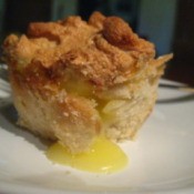 Baked pie on a plate leaking lemon filling.