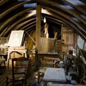 Boat keel style attic with clutter.