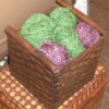 Finished basket storage, with balls of green and purple yarn artfully arranged on top.