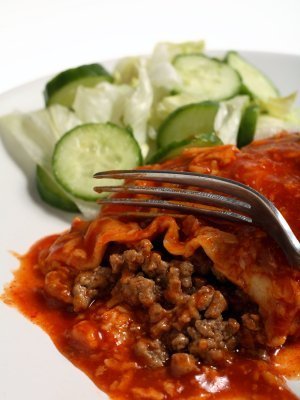 Homemade Enchilada Sauce Recipes, A red enchilada covered in sauce.