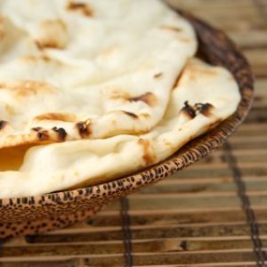 Naan in wooden bowl.