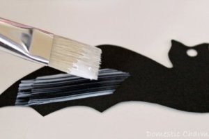Applying Mod Podge to bat wing.