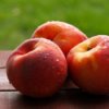 Wet nectarines sitting on a table.