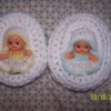 Two baby cradle church purses with Kewpie dolls inside.