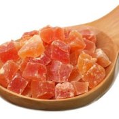 Dried crunks of papaya on wooden spoon