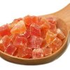 Dried crunks of papaya on wooden spoon