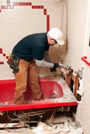 Saving Money on a Bathroom Remodel, Man Working on Remodeling a Bathroom