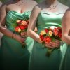 Bridesmaids in different green dresses.