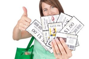 Woman Holding Handful of Coupons with Thumbs Up