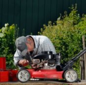 A man winterizing his lawnmower.