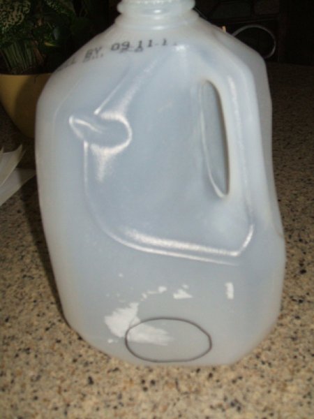 OUtline of hole in the side of a milk jug for a votive.