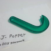 A green J-Popper kitchen tool for opening ring top cans.