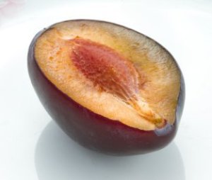 Half of plum on white plate