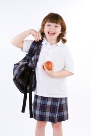 Young Girl with Backpack and Apple Ready for School