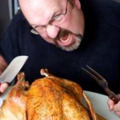 A man eating a turkey alone.
