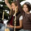 Kids making popcorn garland.