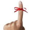 Red Ribbon Tied Around Index Finger