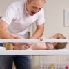 Father Changing a Baby's Diaper