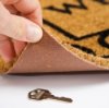 Hiding Keys, A key hidden under a mat.