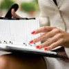 Woman Reviewing Her Busy Schedule in Day Planner