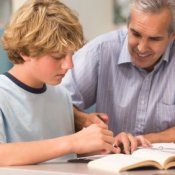 Male Teacher Instructing High School Student