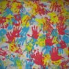 Homemade wrapping paper made with different colored handprints in paint.