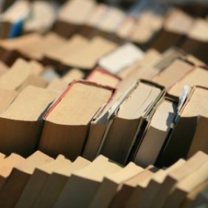Saving Money On Books, Stacks of old books at a flea market or used book sale.