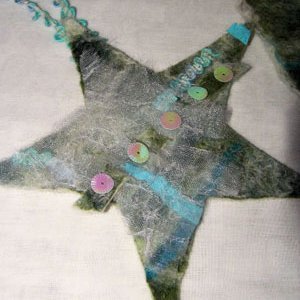 A Christmas star ornament made from felt and embellishments.