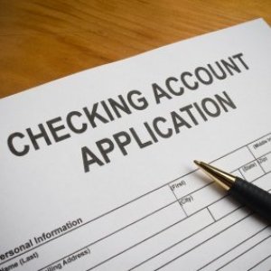Checking account application with a pen.