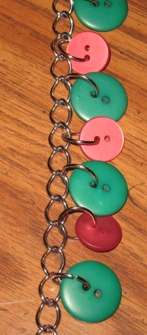 Buttons attached to flat link chain with jump rings.