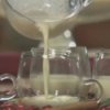 How to Make Eggnog Grog, Pitcher Pouring Eggnog into Glasses