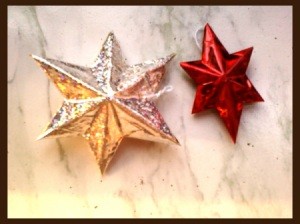 Completed stars, one iridescent silver and one red.