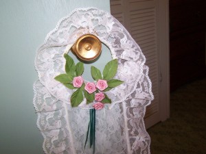 Closeup of TP holder hanging on door knob.