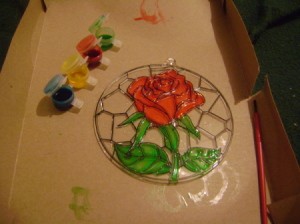 Cardboard box under painted suncatcher project.