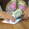 Teaching Children to Save Money, Child Putting Money in Envelope
