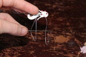 Sewing button on to bobby pin.