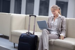 Business Travel Tips, Business Woman on Laptop in Airport