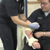 Basic First Aid Skills, Woman applying a tourniquet