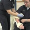 Basic First Aid Skills, Woman applying a tourniquet