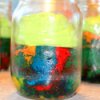 Rainbow cake with frosting, served in the mason jars.