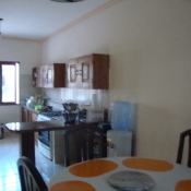 View of the kitchen from table along one wall.