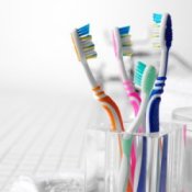 Sanitizing Your Toothbrush, Glass container of toothbrushes.
