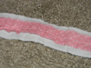 Strips of accent fabric sewn onto muslin for bow..