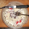 A bowl with surimi, cauliflower and dehydrated cranberries.