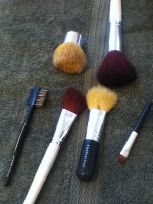 Makeup Brushes after they have been cleaned in a mason jar with marbles.