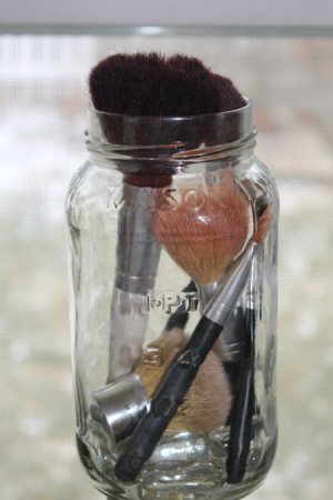 Makeup Brush Cleaner on Makeup Brushes In An Empty Mason Jar With Marbles