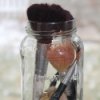 Makeup Brushes in an empty mason jar with marbles.