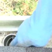 How to Clean Gutters, Man With Gloves on Cleaning Gutter
