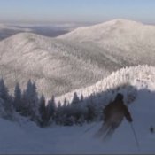 Best Budget Ski Vacations, Skier Coming Down Mountain