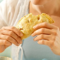 Someone holding a hand pie.
